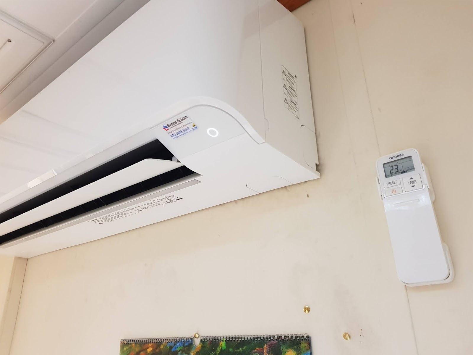 Toshiba wall unit and wall-mounted controller in an office, set to a comfortable 23°C — keeping staff and equipment happy.